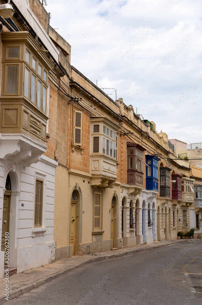 Typical street in Malta with colorful traditional balconies