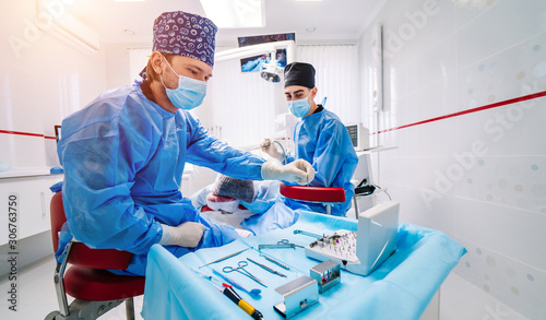 Stomatological instrument in dental clinic. Operation, tooth repairing. Medicine, health, stomatology concept. Doctor in mask. Selective focus. photo