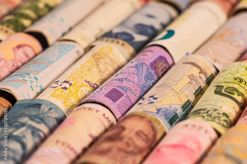 Different banknotes from various countries on rolls