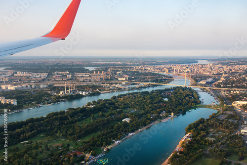 Airplane flying over Belgrade cityscape in Serbia