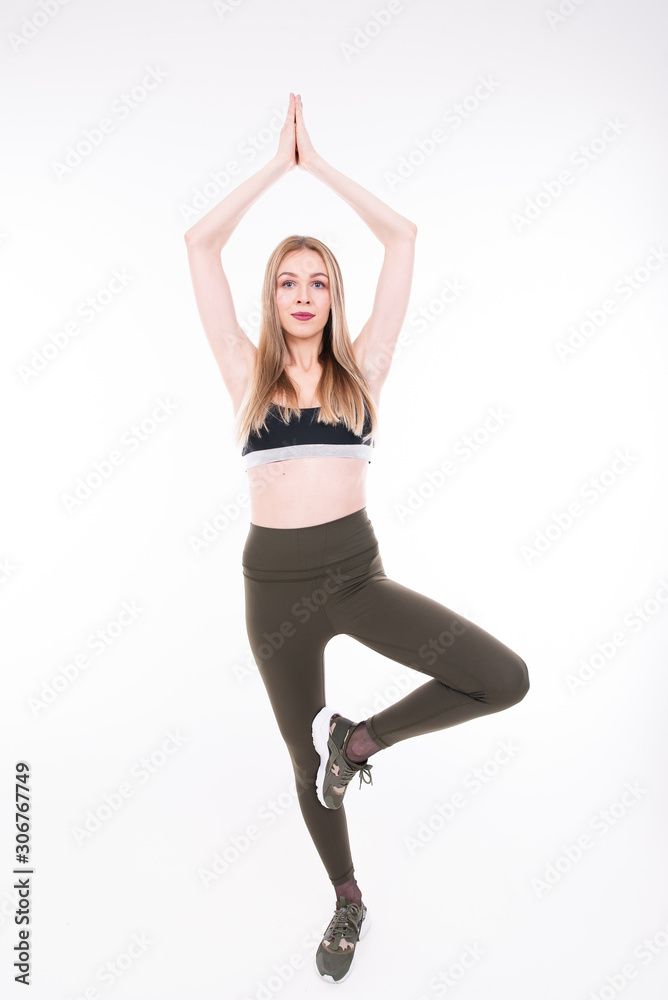 Young beautiful girl goes in for sports on white background Young beautiful girl goes in for sports on white background