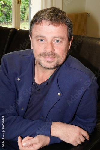 Portrait of happy handsome mature man at home couch house