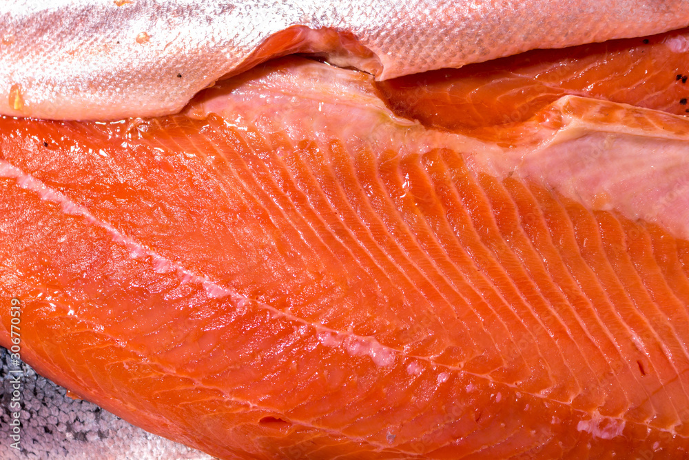 Pieces of red fish with skin. Chilled meat with bones, preparation for processing