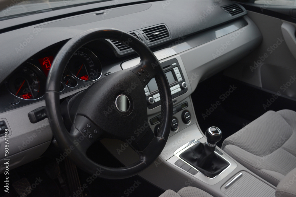 Car Interior. Steering wheel and dashboard in a car interior. Shiny and Black
