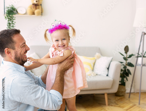 Happy daughter playing with her loving dad