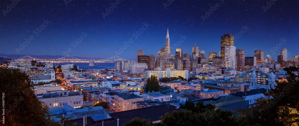 San Francisco night cityscape with wonderful yellow light glow and blue sky in California, USA