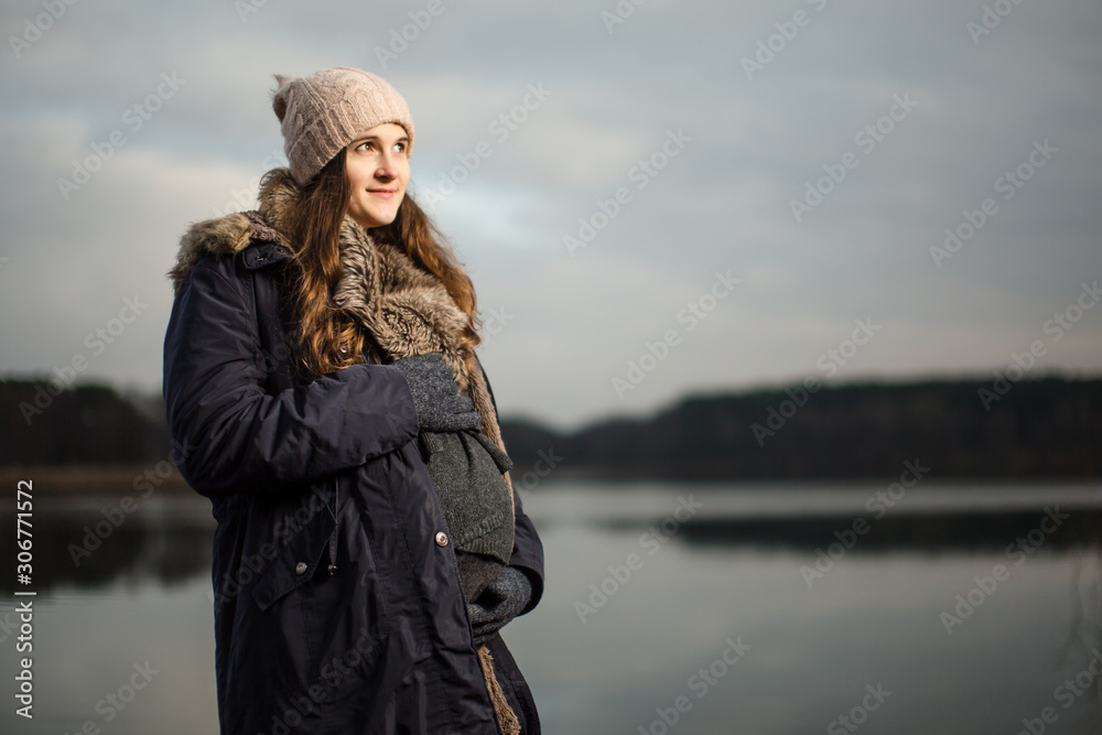 Pregnant woman in a forest or grass in autumn or winter. Pregnancy photo of standing woman in a high grass. wearing hat jacket cold whether Pregnant woman in a forest or grass in autumn or winter. Pregnancy photo of standing woman in a high grass. wearing hat jacket cold whether