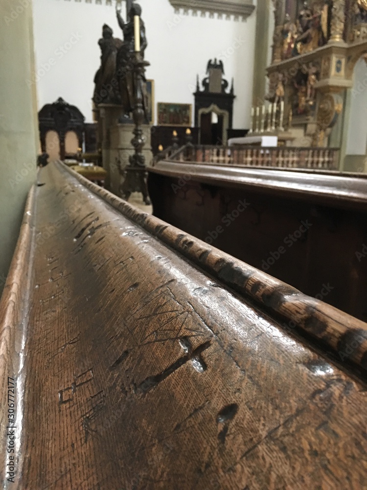 Bench (Pew) wooden board with crusifix in Cathedral Catholic church