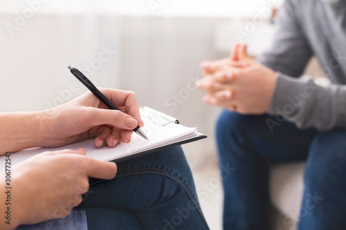 Therapist noting patient speech during personal session photo