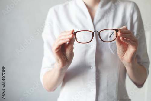 Ophthalmologist make you try new glasses. Hyperopia or myopia concept