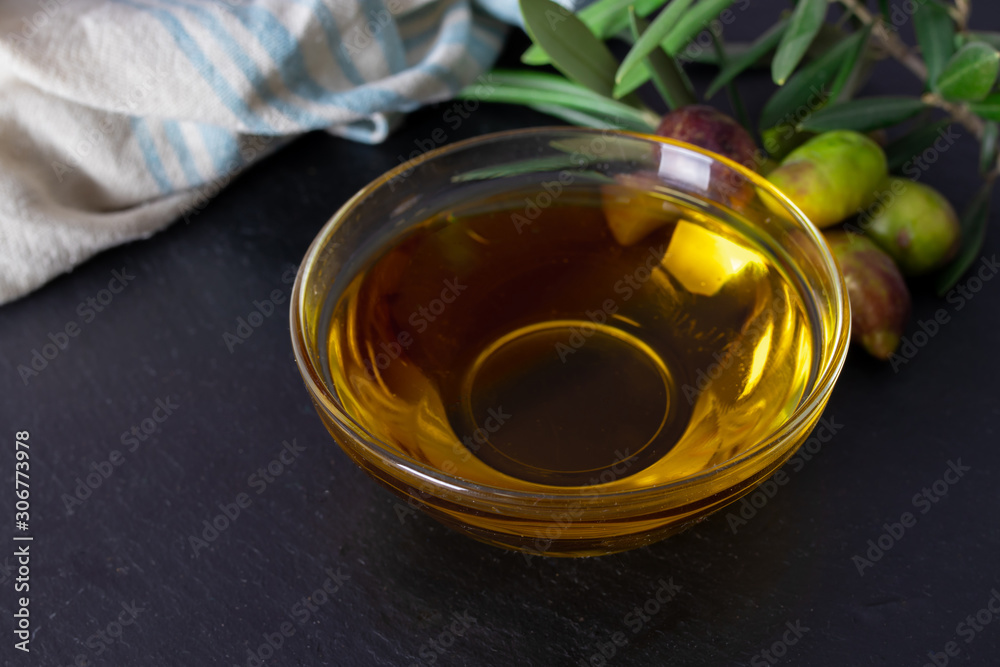 glass vessel with extra virgin olive oil and natural olives with olive branches glass vessel with extra virgin olive oil and natural olives with olive branches