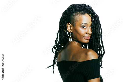 Valokuva African American woman with dreadlocks looking at the camera over her shoulder