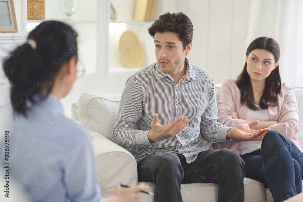 Young man explaining himself to family therapist Young man explaining himself to family therapist