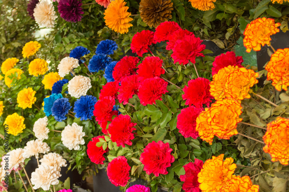 Close-up of a colorful, wood carved flowers market in Pucon, Chile. This artisanal flowers are the most typical handicraft of the region, they are locally made by hand and a beautiful travel souvenir