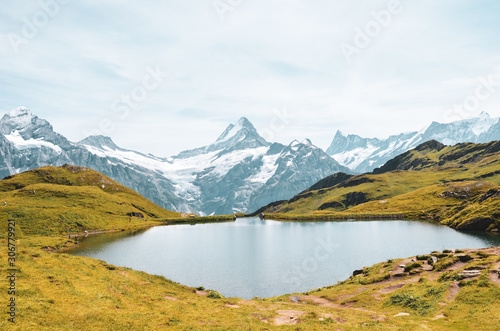 Amazing Bachalpsee in the Swiss Alps photographed with famous mountain peaks Eiger, Jungfrau, and Monch. Lake and Alpine landscape. Snow-capped mountains, mountain range. Switzerland nature