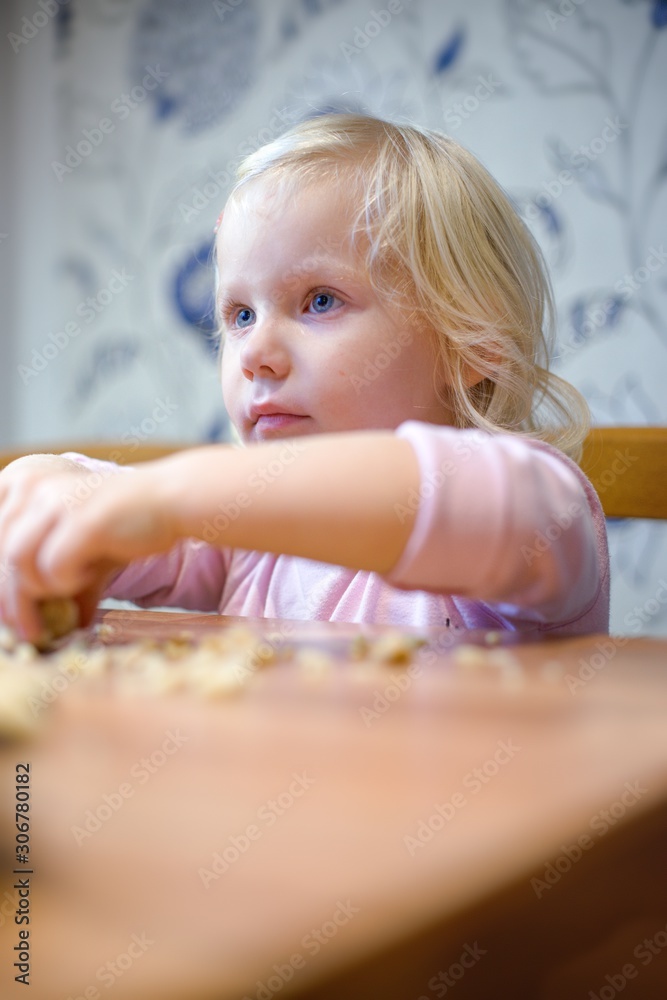 Little girl helping in the kitchen with baking Christmas cookies. Little girl helping in the kitchen with baking Christmas cookies.