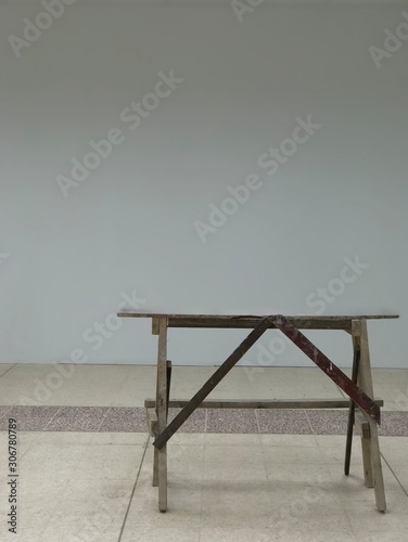 The wooden sawhorse table is at the construction site