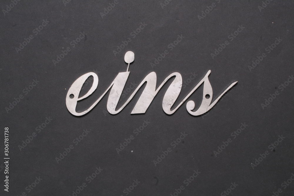 Fototapeta premium number in handwriting made of stainless steel, house number,