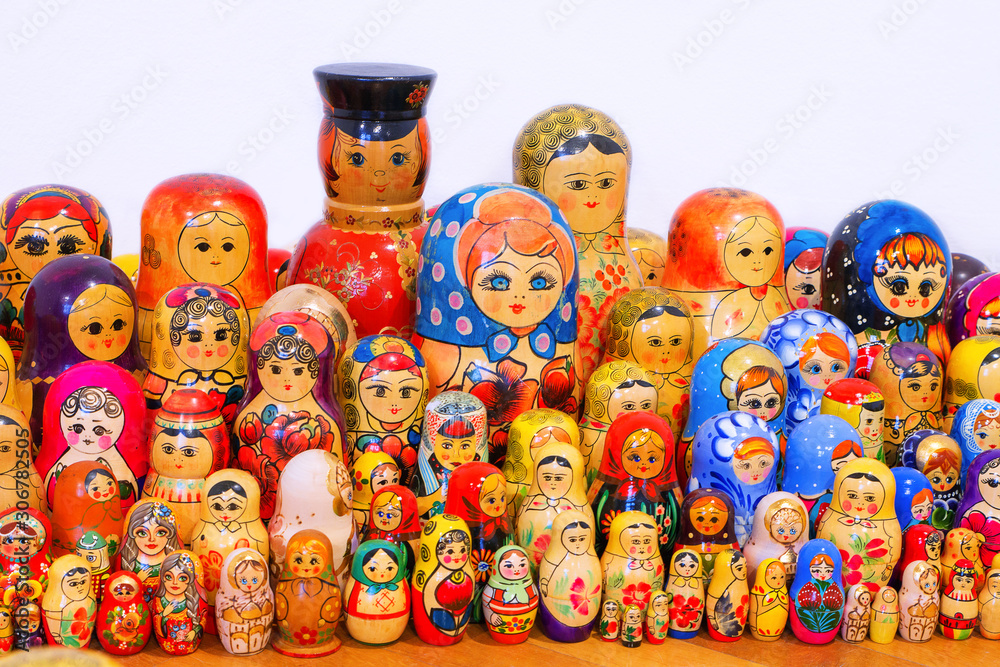 Russian nesting doll - a traditional wooden Russian toy. Souvenir from Russia. A collection of different size nesting dolls on a white background.