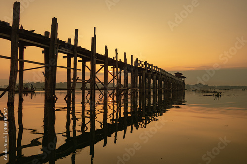 Sunrise view of the ancient teak wood U Bein Bridge that stretches across Taungthaman Lake at Amarapura, near the city of Mandalay in Myanmar (formerly called Burma)