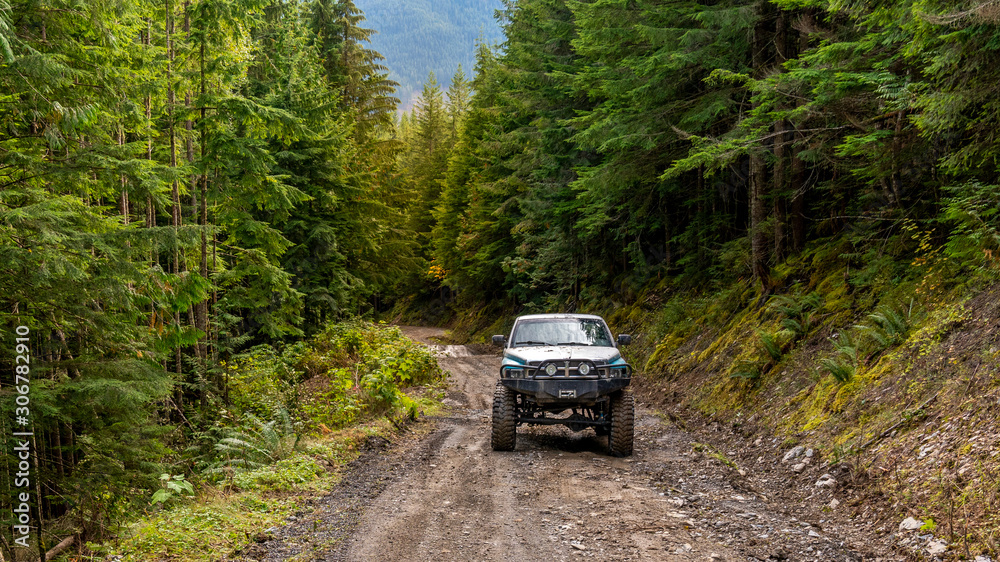 British Columbia, Canada. Off-road monster truck in the forest. British Columbia, Canada. Off-road monster truck in the forest.