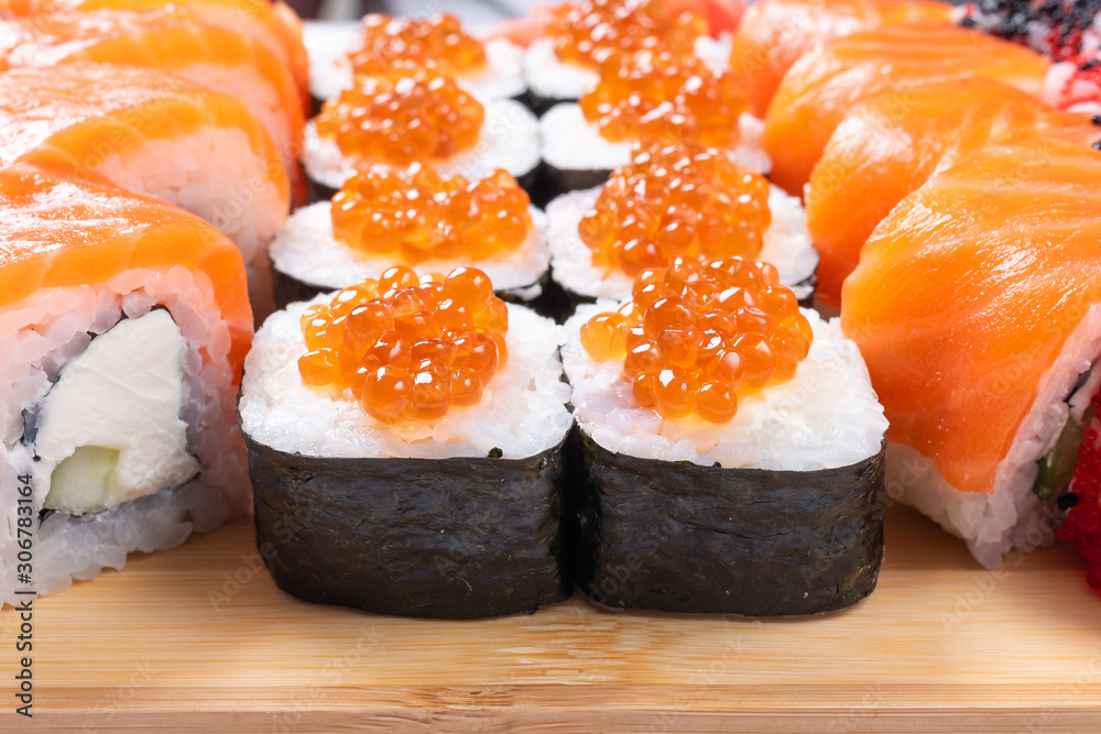Sushi set of rolls and poppies, with salmon and caviar. Close-up. Sushi set of rolls and poppies, with salmon and caviar. Close-up.
