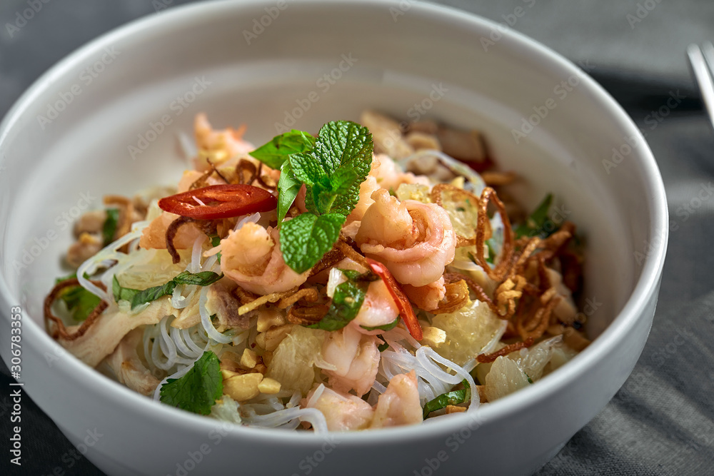 Rice noodles with shrimps and seafood, spicy asian style noodles in bowl. Rice noodles with shrimps and seafood, spicy asian style noodles in bowl.