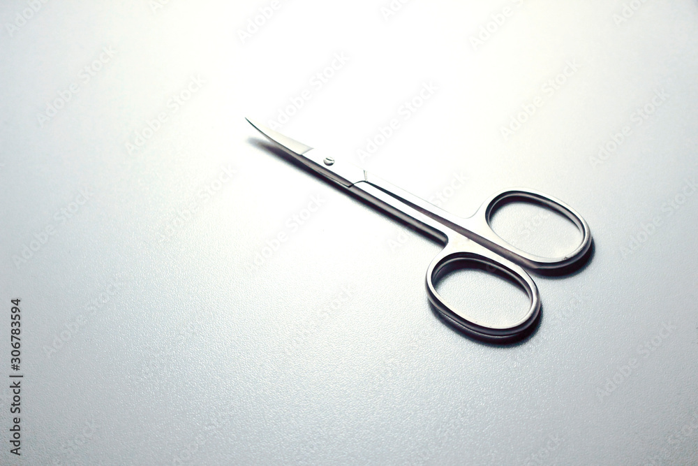 silver steel nail scissors. scissors on a neutral background silver steel nail scissors. scissors on a neutral background