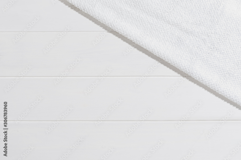 Towel on white planks background. Top view with copy space Towel on white planks background. Top view with copy space