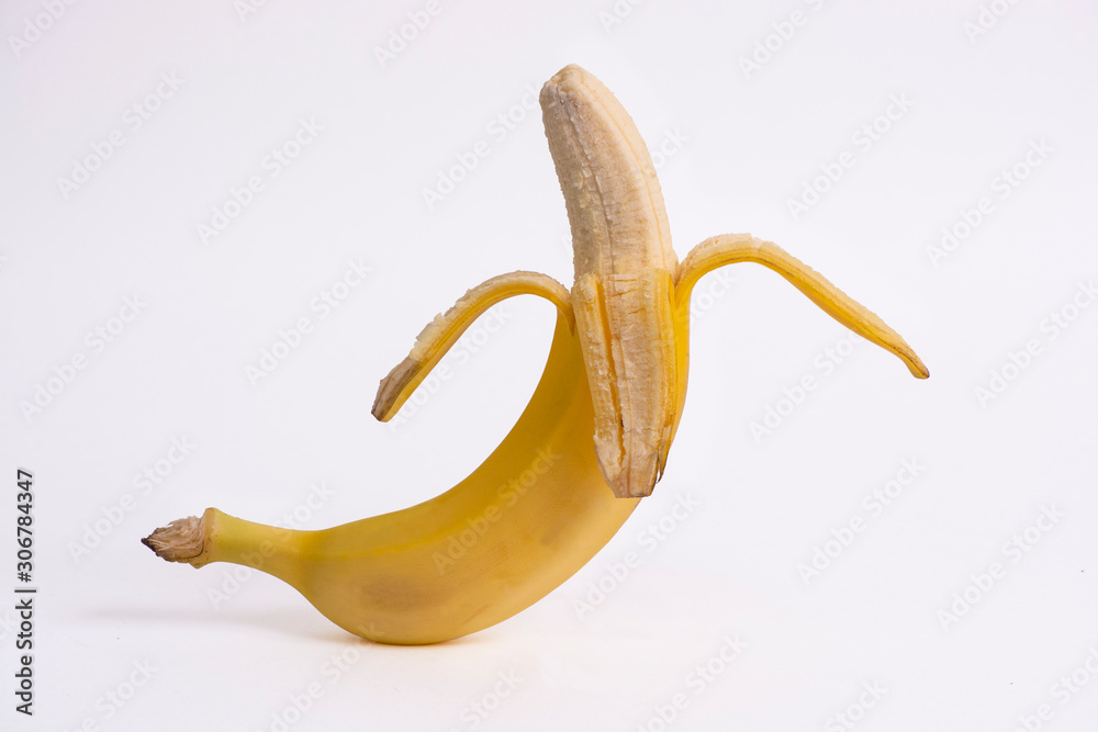 Half peeled banana on a white background.
