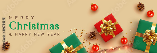 Christmas banner. Background Xmas design of realistic red and green gifts box, golden glitter confetti, bauble ball, light garlands. Horizontal New Year poster, greeting card, headers for website