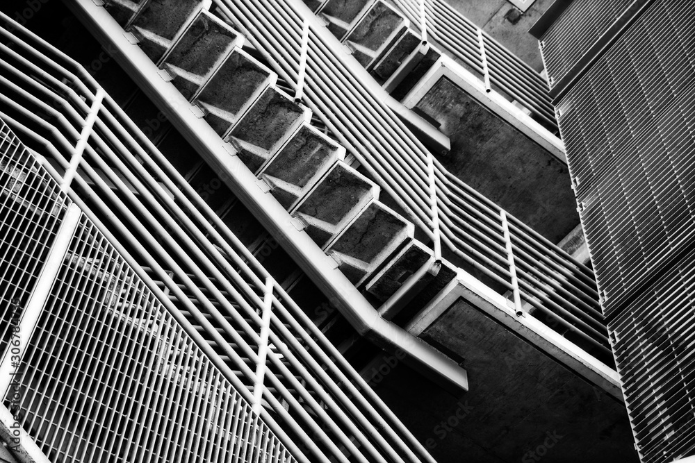 Fototapeta premium Underneath Staircase on outside of building -black and white