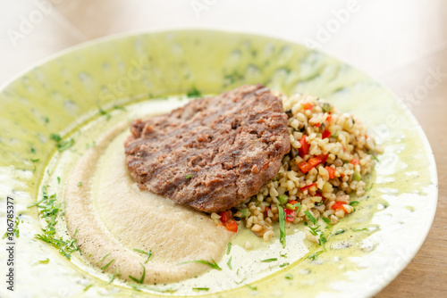Plate with Beefsteak marbled beef, served with bulgur and smoked onion cream. Barbecue restaurant menu, a series of photos of different meats