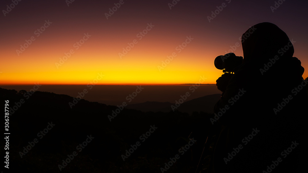 The black silhouette of the photographer taking pictures
