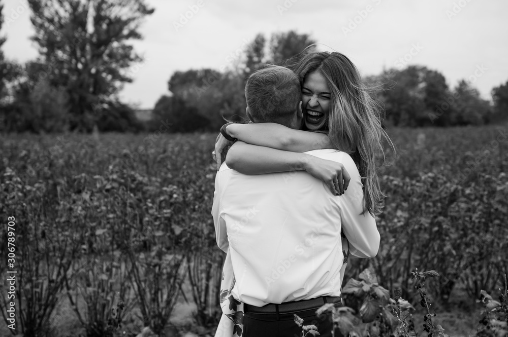 A girl and a guy are walking in the nature. Portrait of a couple, a love story.Happy smiling, loveing couple together outstretched at beautiful nature. Lovestory A girl and a guy are walking in the nature. Portrait of a couple, a love story.Happy smiling, loveing couple together outstretched at beautiful nature. Lovestory