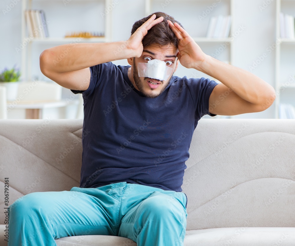 Young man recovering healing at home after plastic surgery nose Young man recovering healing at home after plastic surgery nose