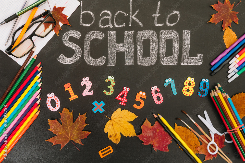 Back to school concept. School and office supplies on blackboard background. Back to school concept. School and office supplies on blackboard background.