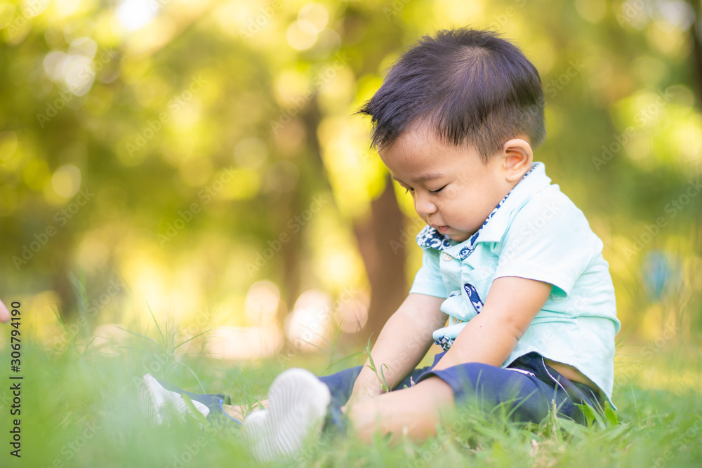 Adorable smart baby boy playing in city green park Adorable smart baby boy playing in city green park