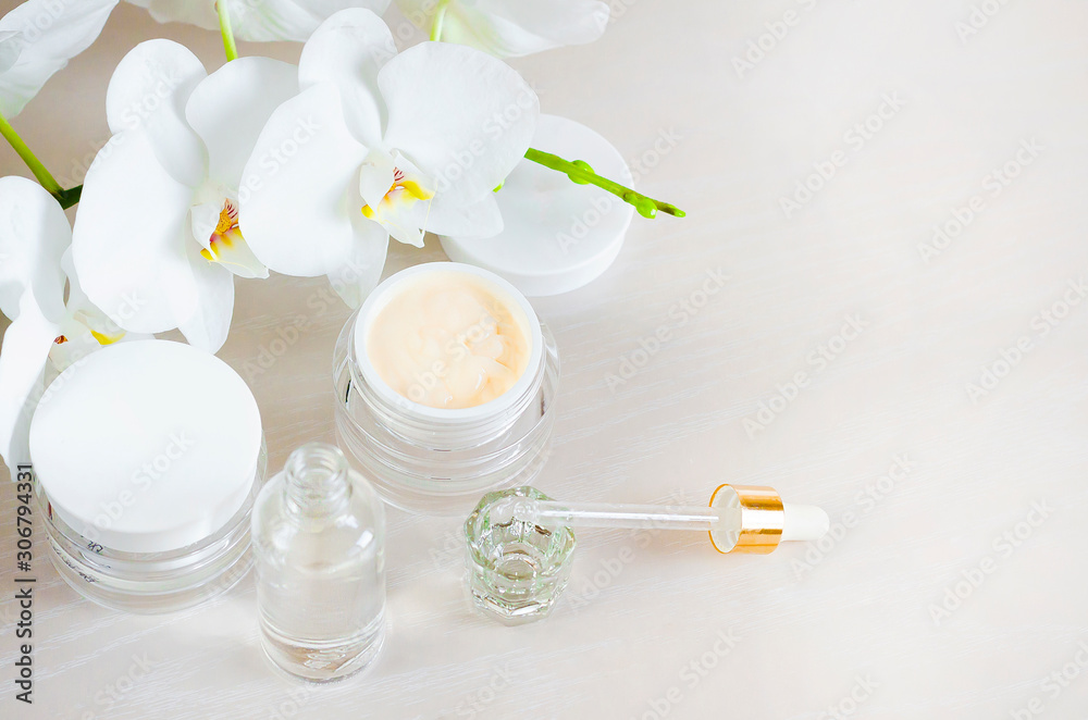 beauty concept. natural cosmetic product, preparation, cream, serum with white orchid extract for professional use in cosmetology, salon, for home skin and face skin care. copy space, soft focus beauty concept. natural cosmetic product, preparation, cream, serum with white orchid extract for professional use in cosmetology, salon, for home skin and face skin care. copy space, soft focus