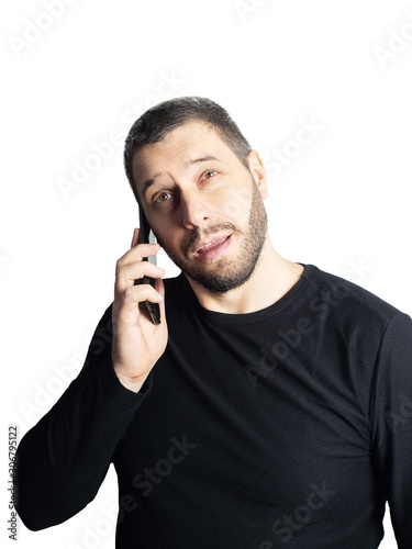 Pretty man with a beard talking on the phone on a white background