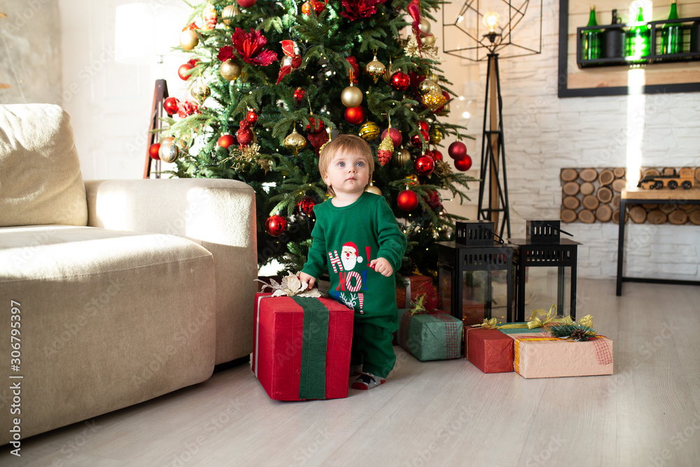 little child playing with Christmas gift boxes