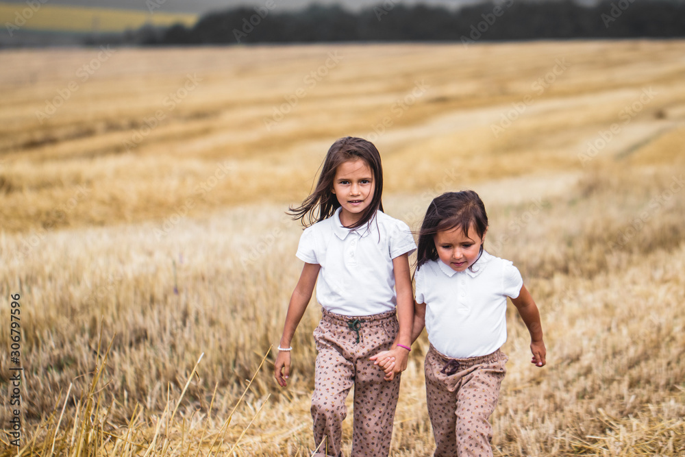 Little girl running across the sunny field. Little girl running across the sunny field.