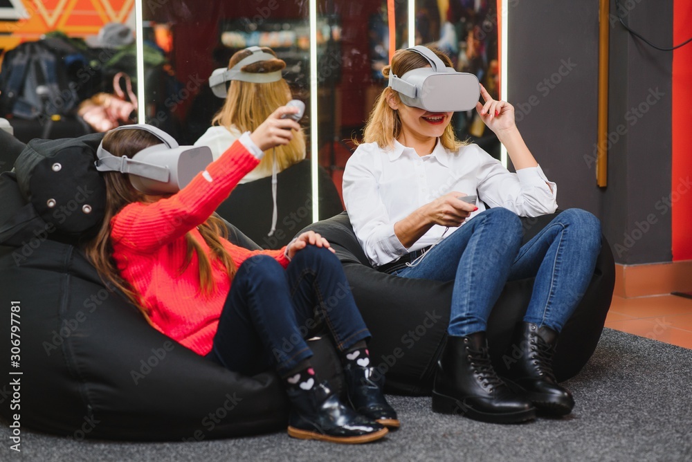 Mother and child playing together with virtual reality headsets
