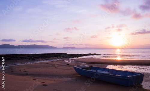 Small boat on an empty beach at sunset © Alberto