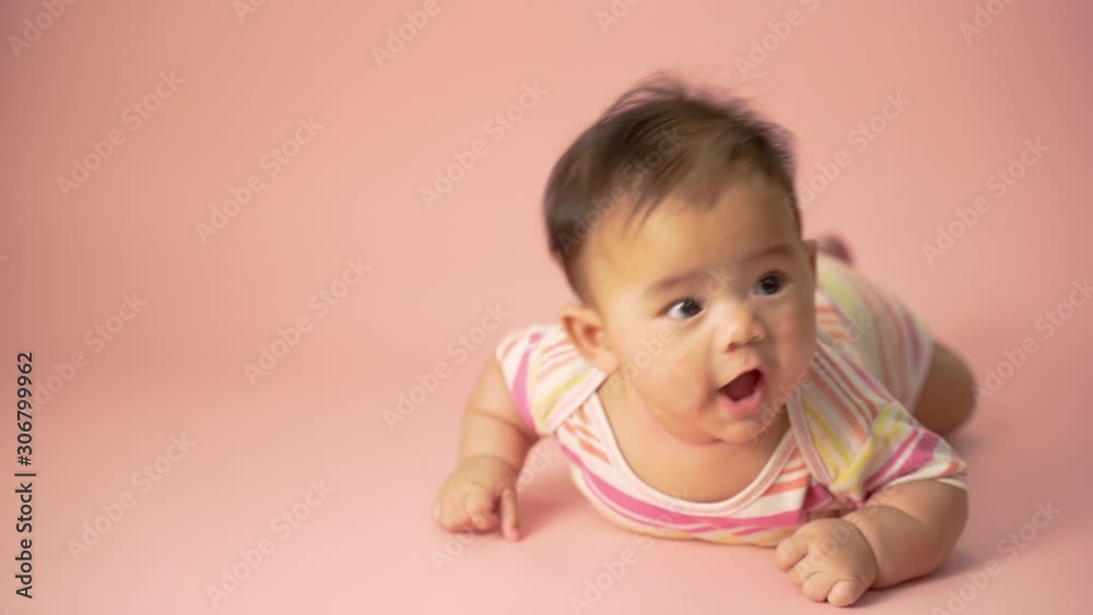 baby laying on her belly. tummy time cute baby in studio portrait baby laying on her belly. tummy time cute baby in studio portrait