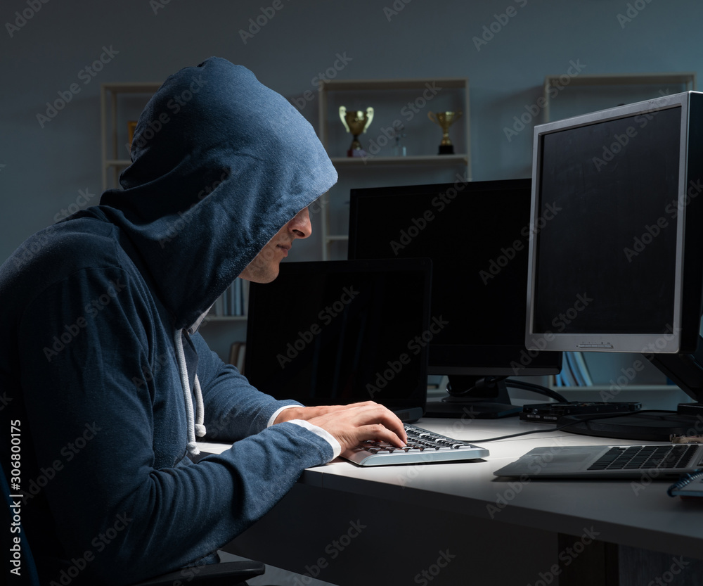 Hacker hacking computer at night Hacker hacking computer at night