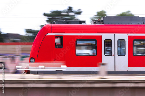 passenger tram train speeding through a station