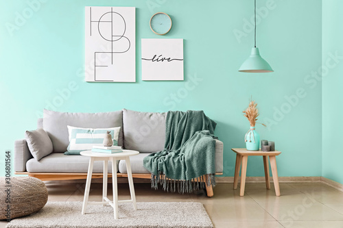 Stylish interior of living room in turquoise color photo