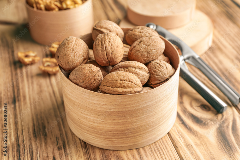 Box with tasty walnuts on wooden table Box with tasty walnuts on wooden table