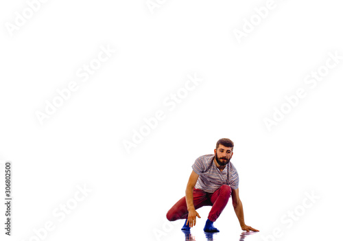 Man is dancing in the studio on a white background © qunica.com